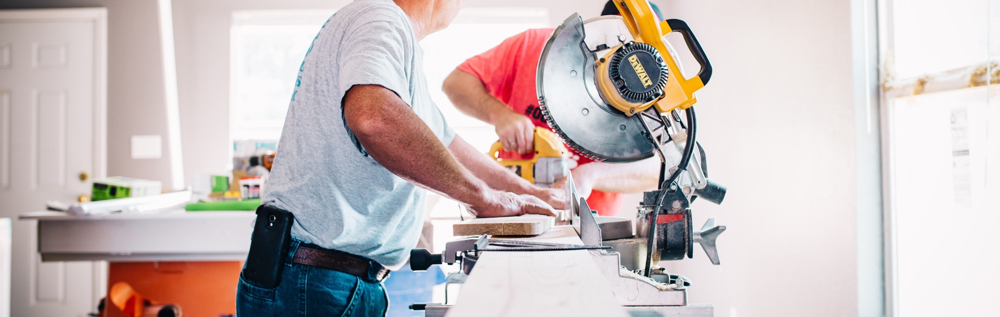 man standing infront of miter saw